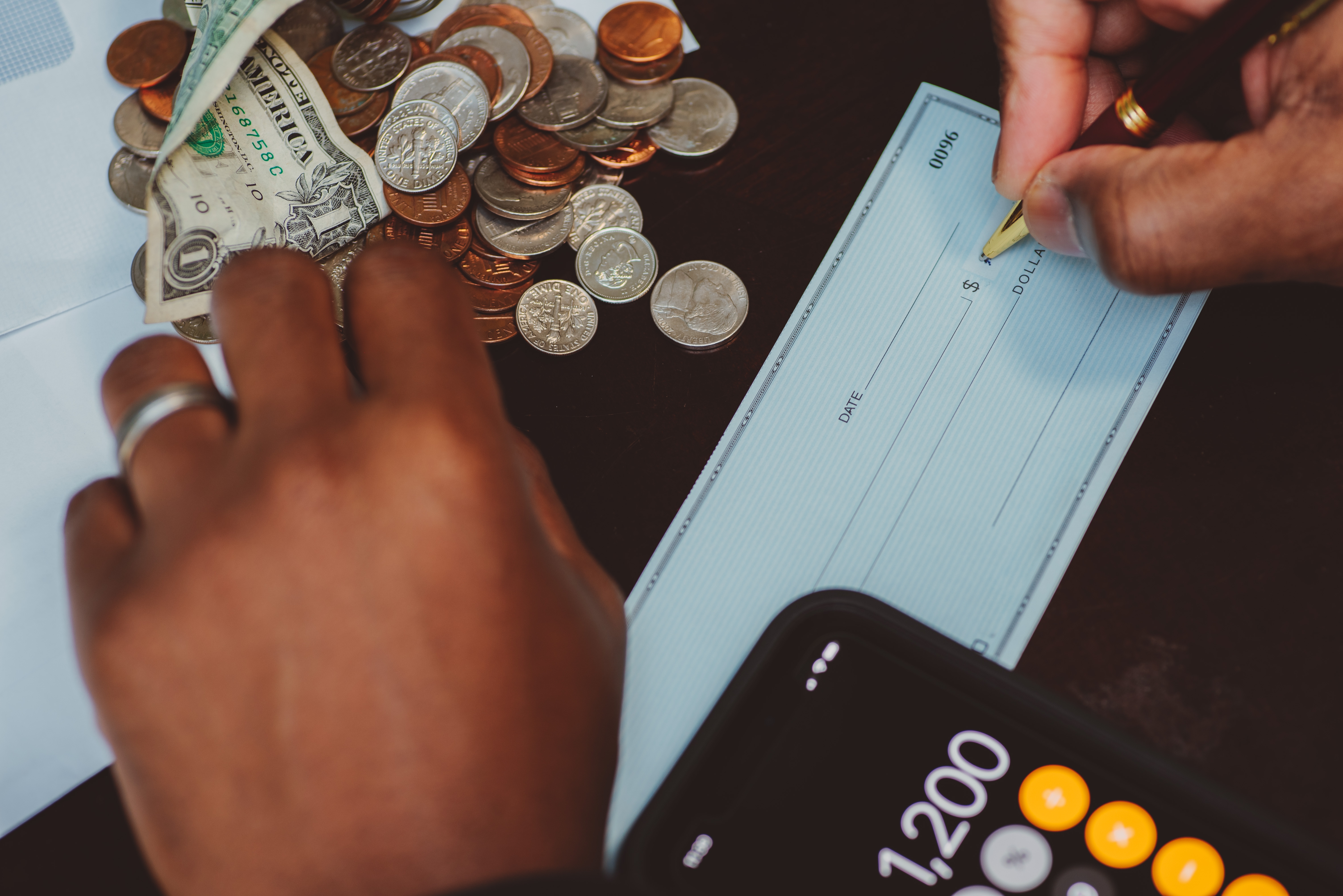 African American man at home office writing out a check